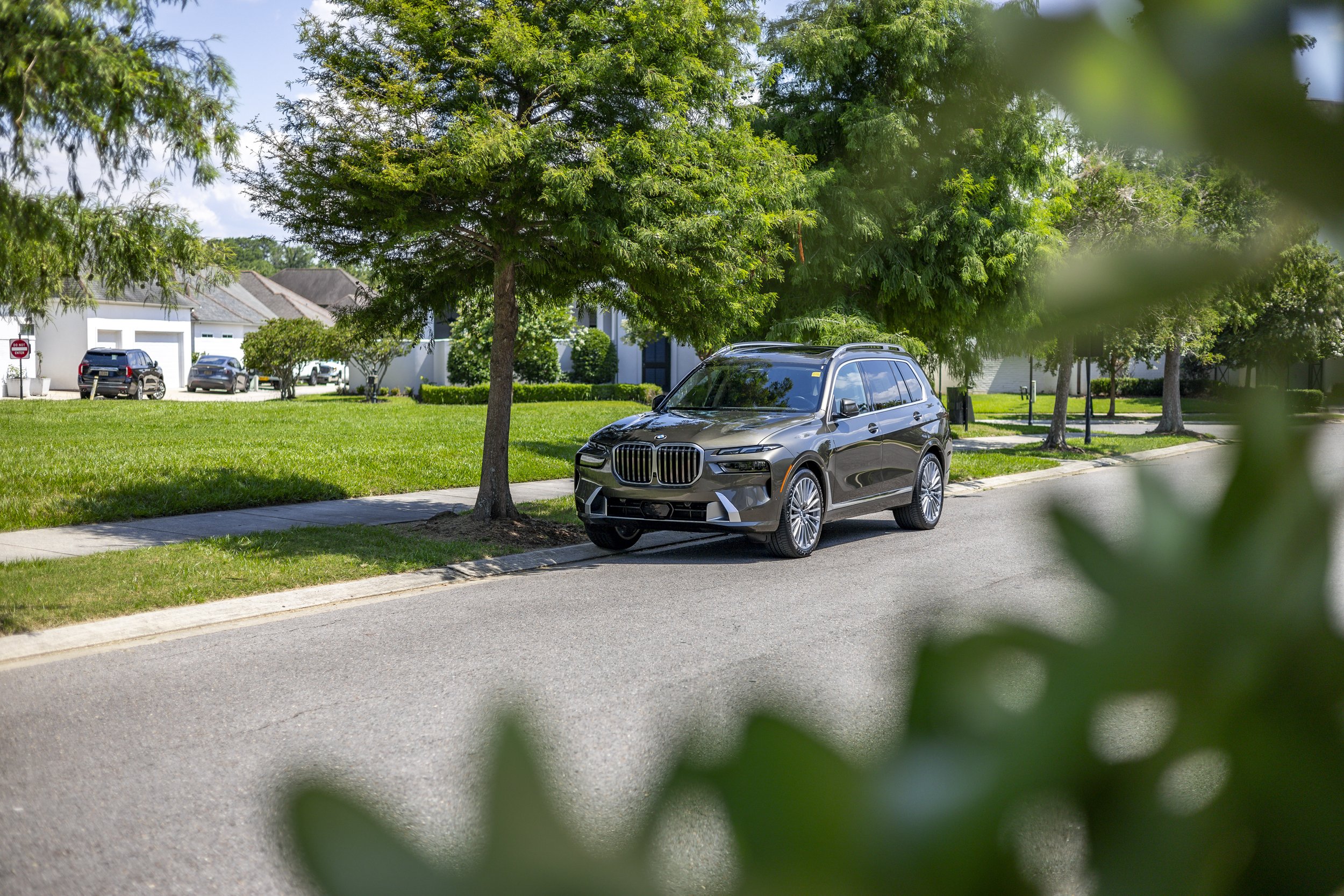 BMW X7 on tree-lined street